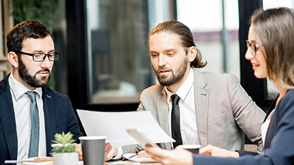 Three people in business discussion